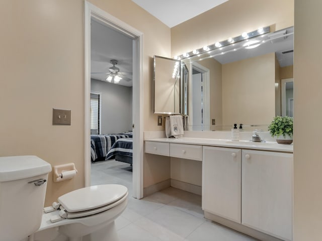 bathroom with toilet, ceiling fan, tile patterned floors, and vanity