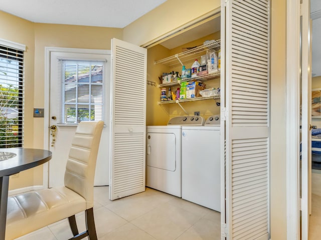 laundry area with light tile patterned flooring and washing machine and clothes dryer