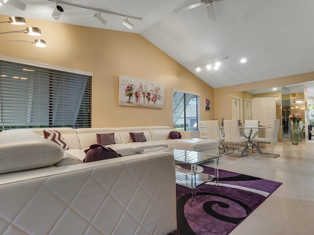 living room with ceiling fan, tile patterned flooring, and lofted ceiling