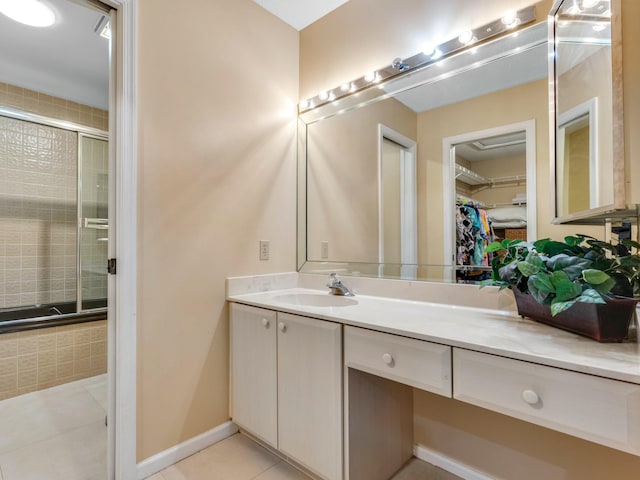 bathroom with vanity, tile patterned floors, and a shower with shower door