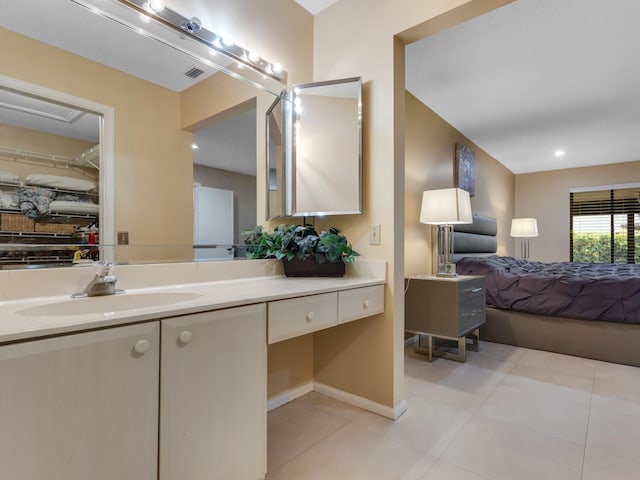 bathroom featuring tile patterned flooring and vanity