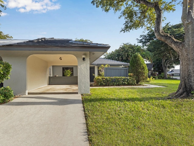 exterior space featuring a front lawn and a carport