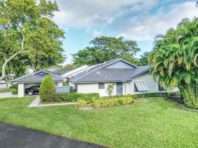 ranch-style home featuring a front yard and a carport