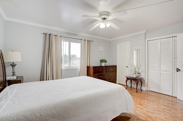 bedroom with tile patterned flooring, ceiling fan, crown molding, and multiple closets