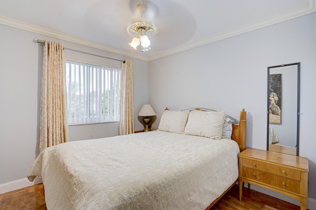 bedroom with dark wood-type flooring, ceiling fan, and crown molding