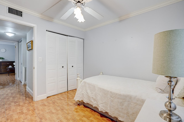 tiled bedroom featuring a closet, ceiling fan, and ornamental molding