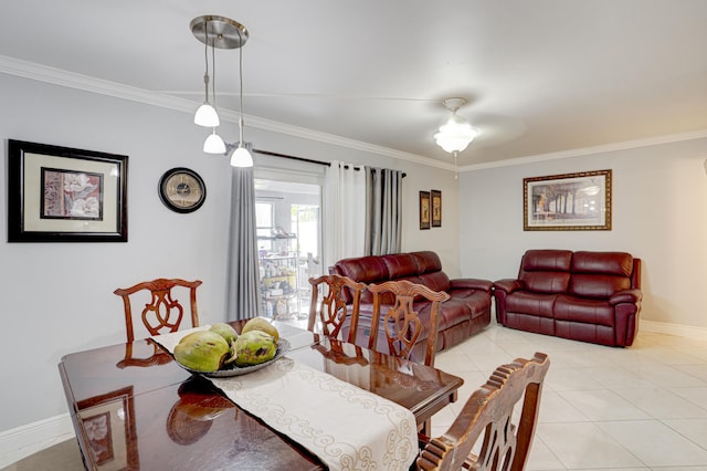 tiled dining area with ceiling fan and crown molding