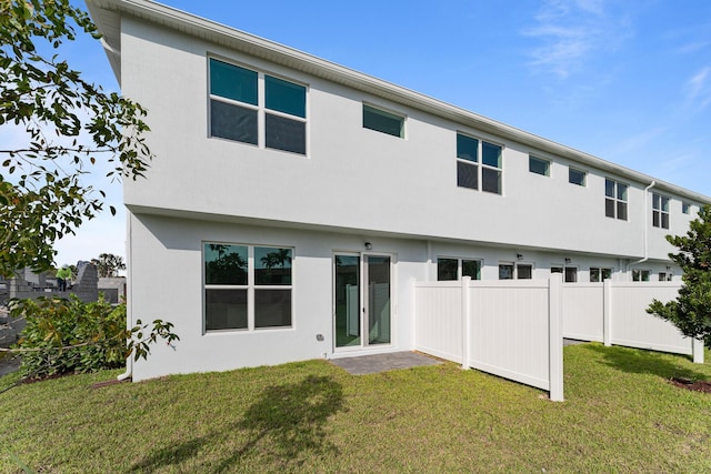 rear view of property with a yard