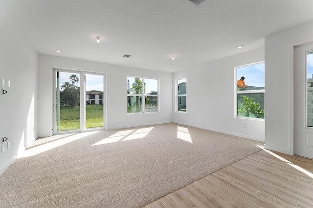 empty room with light hardwood / wood-style flooring