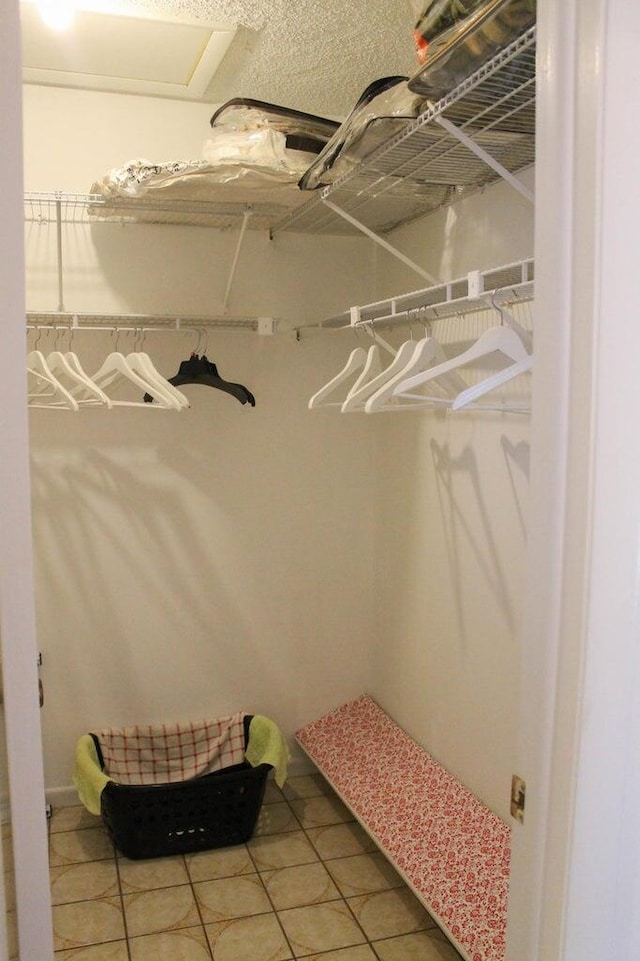 spacious closet featuring tile patterned flooring