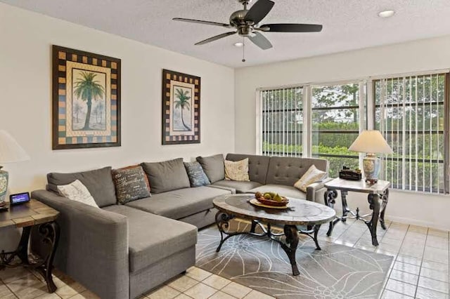 tiled living room featuring ceiling fan and a textured ceiling