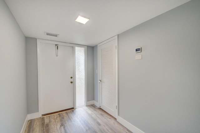 foyer entrance with light hardwood / wood-style floors