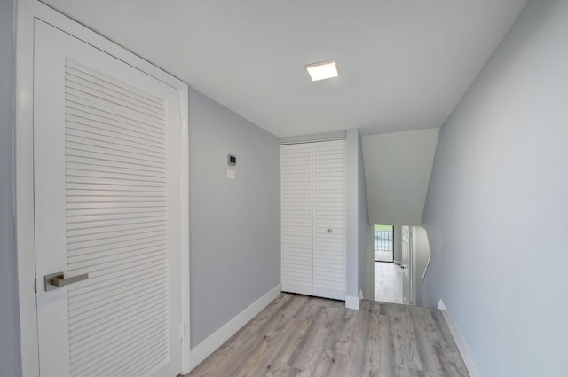 hallway with light hardwood / wood-style floors