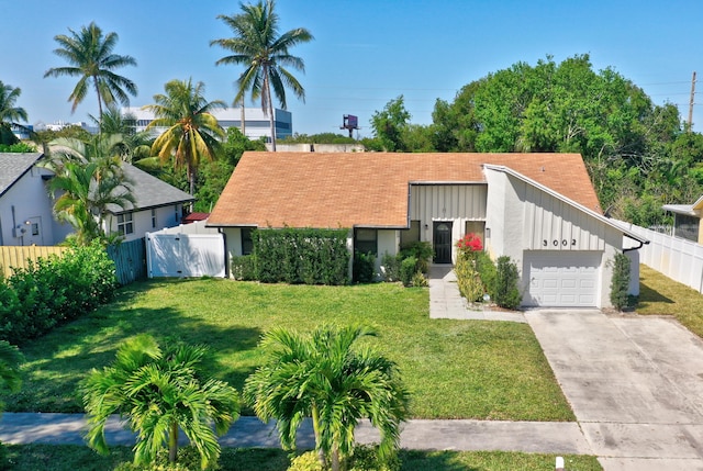 view of front of home featuring a front lawn and a garage