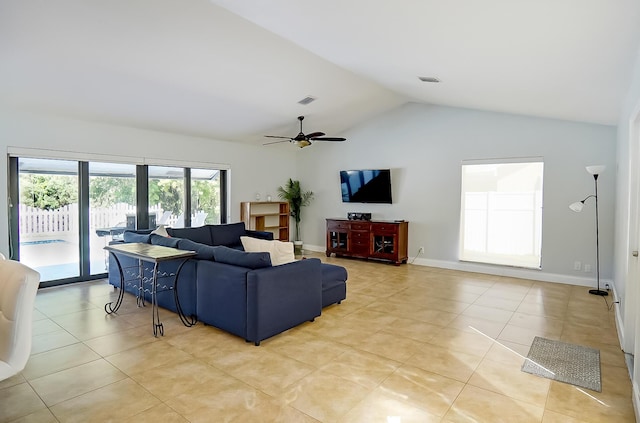 tiled living room with ceiling fan and lofted ceiling