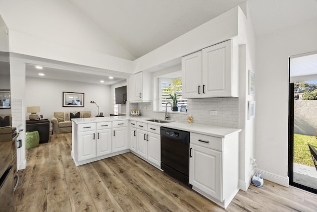 kitchen with light hardwood / wood-style floors, kitchen peninsula, dishwasher, white cabinets, and sink