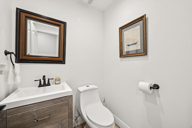 bathroom with toilet and vanity