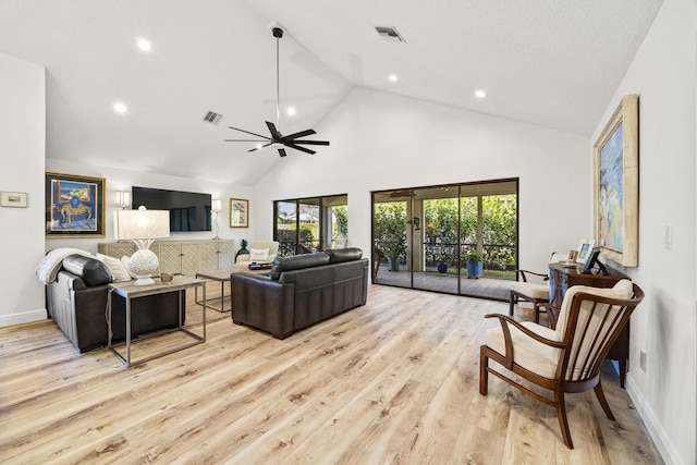 living room with ceiling fan, high vaulted ceiling, and light wood-type flooring