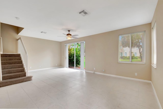 tiled spare room with ceiling fan