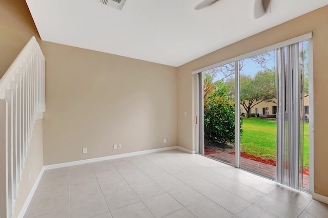 tiled empty room featuring ceiling fan and a wealth of natural light