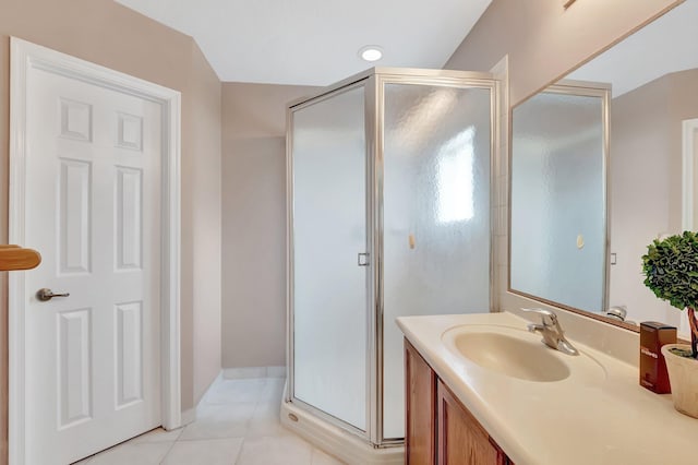 bathroom featuring tile patterned flooring, an enclosed shower, and vanity