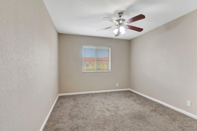 empty room featuring ceiling fan and carpet flooring