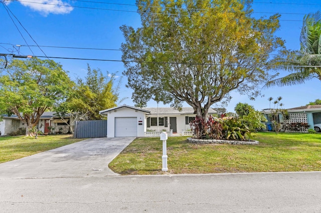 single story home with a garage and a front lawn