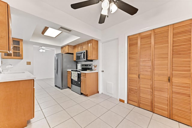 kitchen with ceiling fan, light tile patterned floors, a sink, visible vents, and appliances with stainless steel finishes