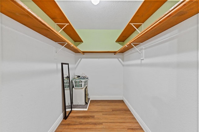 spacious closet with wood finished floors