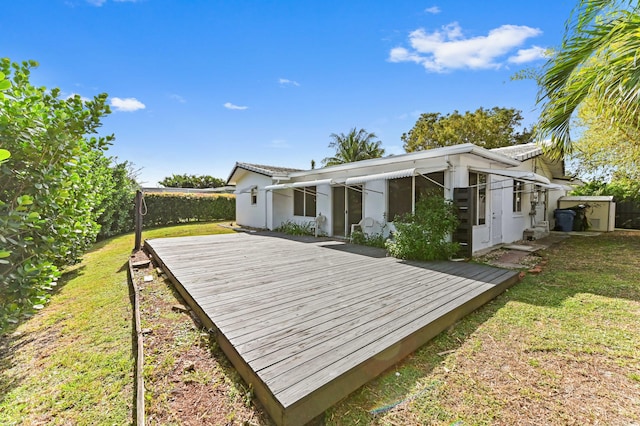 back of house with a yard, a wooden deck, and fence