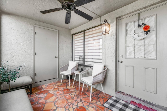 doorway to property featuring ceiling fan