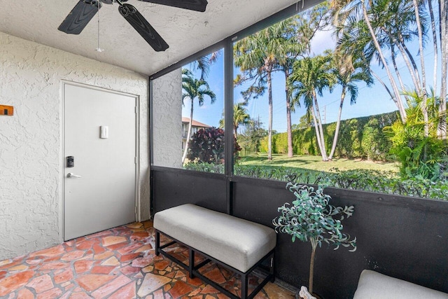 sunroom / solarium featuring ceiling fan