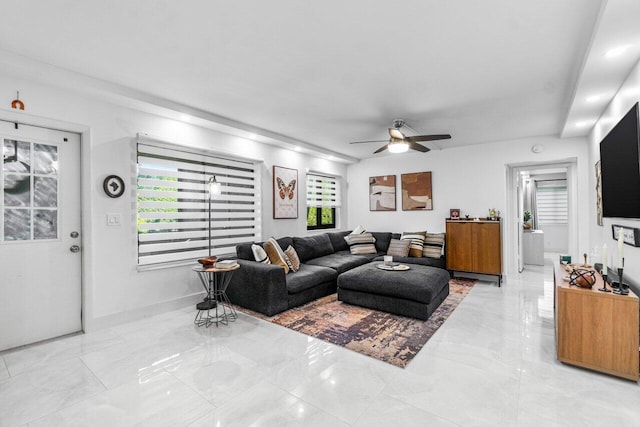 living room featuring ceiling fan and a wealth of natural light