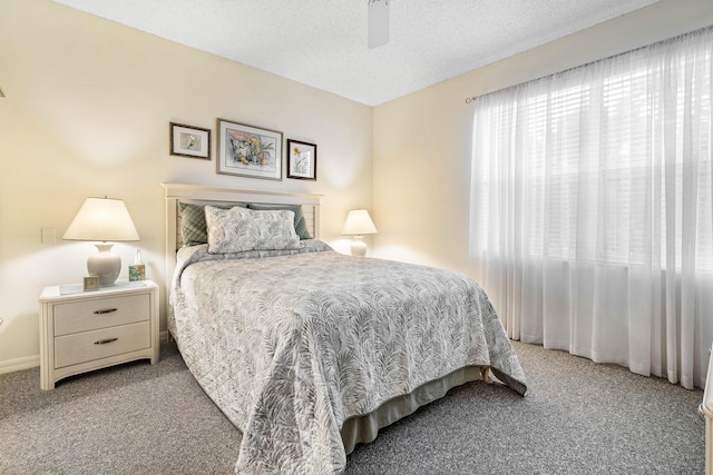 bedroom featuring a textured ceiling, ceiling fan, and carpet flooring