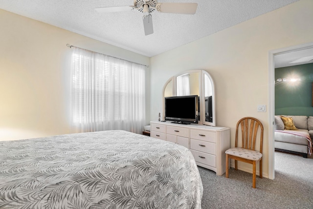 carpeted bedroom with a textured ceiling and ceiling fan