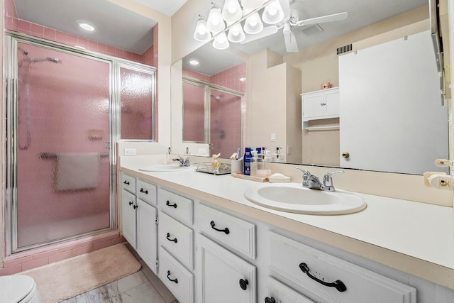 bathroom featuring an enclosed shower, vanity, and toilet