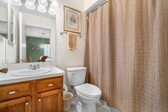 bathroom featuring toilet, tile patterned floors, and vanity