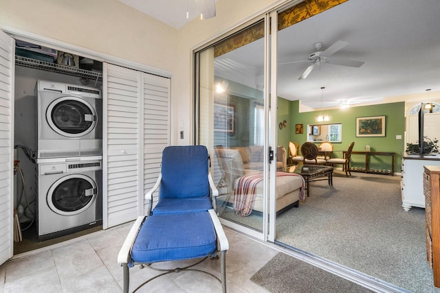 laundry area featuring stacked washer / drying machine