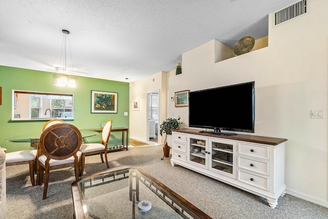 living room with a textured ceiling, carpet floors, and sink