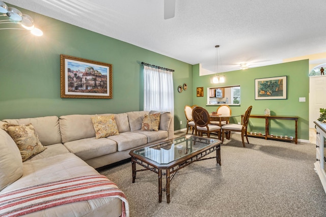 carpeted living room featuring a textured ceiling