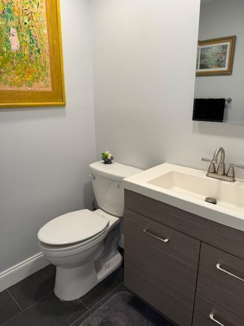 bathroom featuring toilet, vanity, and tile patterned floors