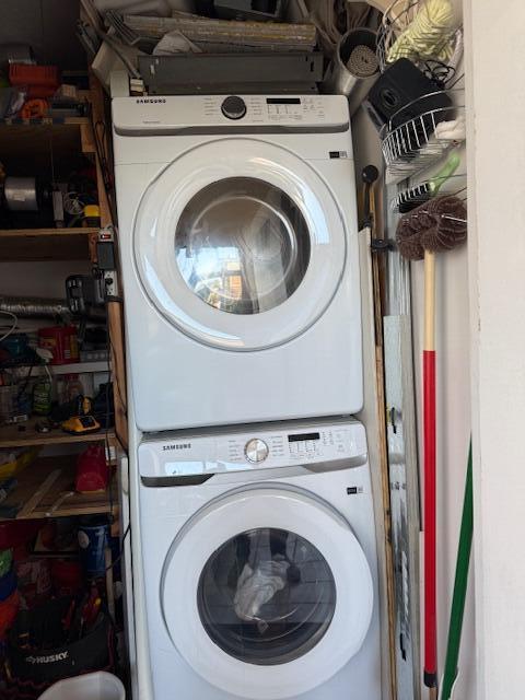 laundry area featuring stacked washer / drying machine