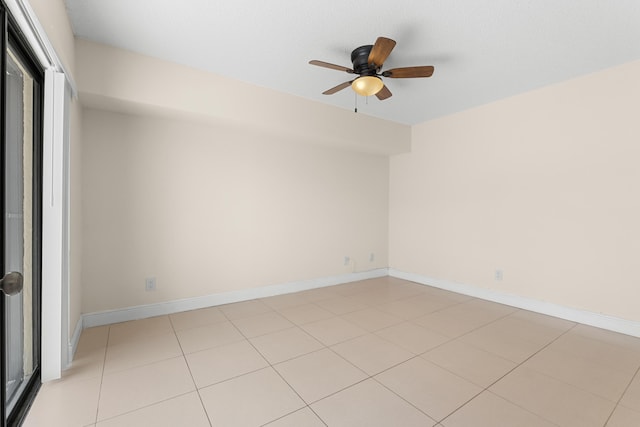 tiled spare room with ceiling fan