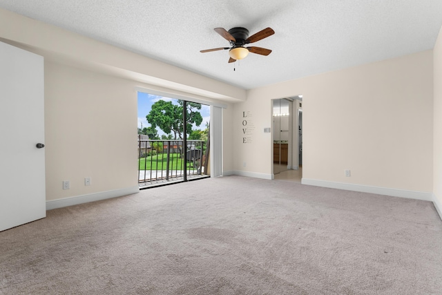 carpeted empty room with a textured ceiling and ceiling fan