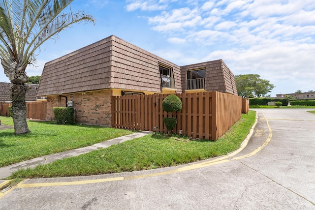 view of side of property with a yard