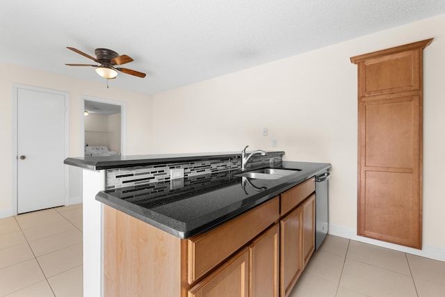 kitchen featuring kitchen peninsula, ceiling fan, sink, and dishwasher