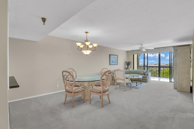 dining room featuring a textured ceiling, carpet, and ceiling fan with notable chandelier