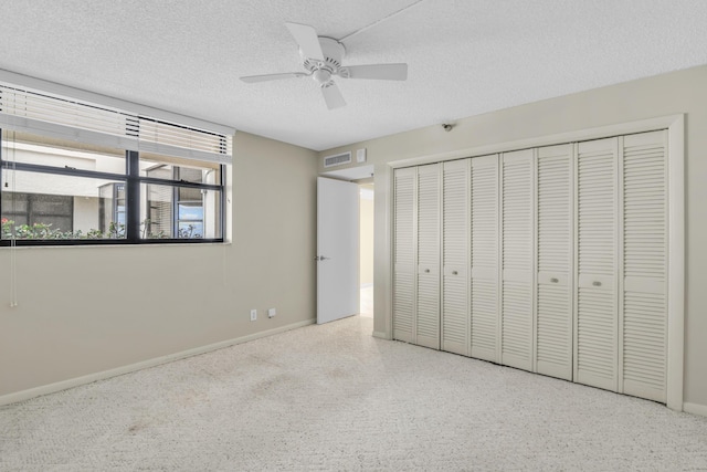 unfurnished bedroom featuring ceiling fan, a closet, and a textured ceiling