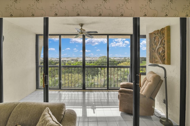 sunroom featuring ceiling fan