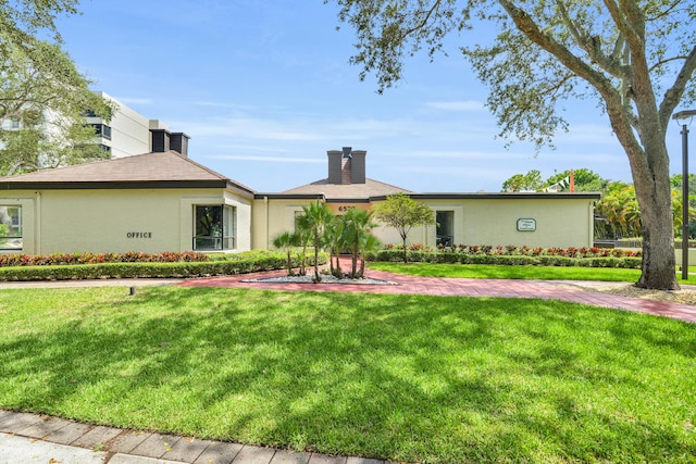 ranch-style house with a front lawn